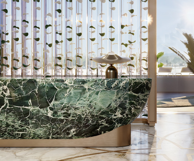 Green marble reception desk in front of a decorative glass screen